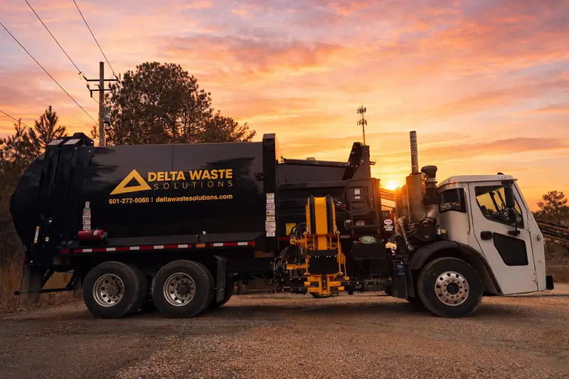 Black Delta Waste Solutions automated side-loader garbage truck